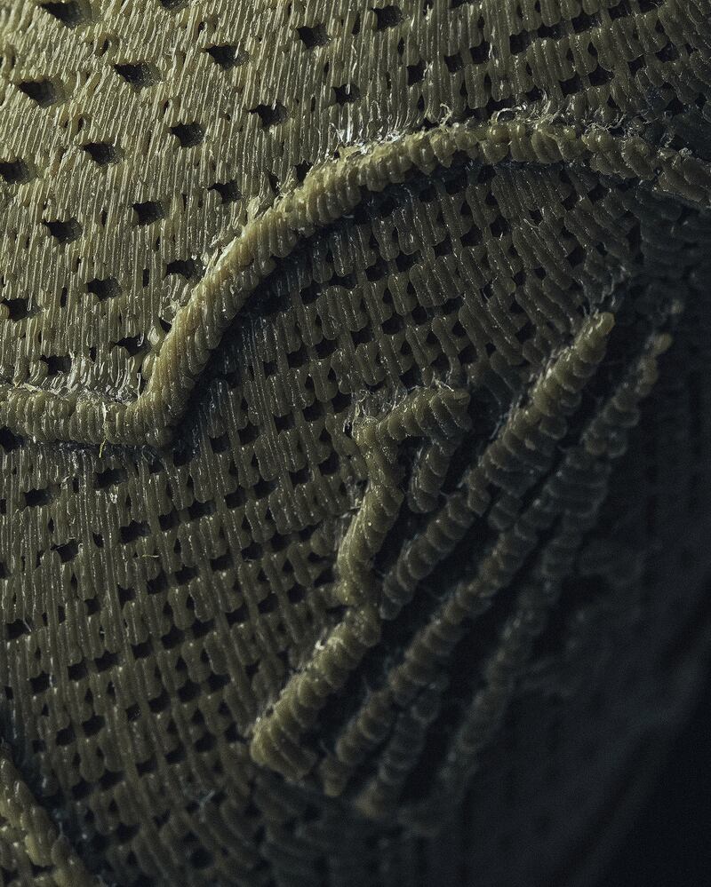 A close-up shot shows the texture of the 3D-printed material.